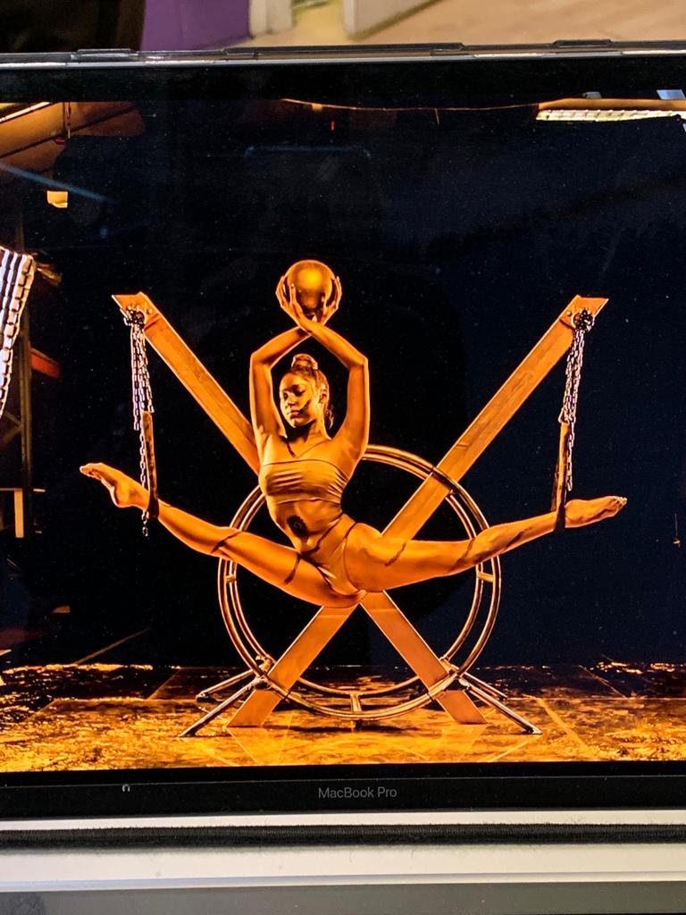 Azra Dewan in gold body art, standing portrait